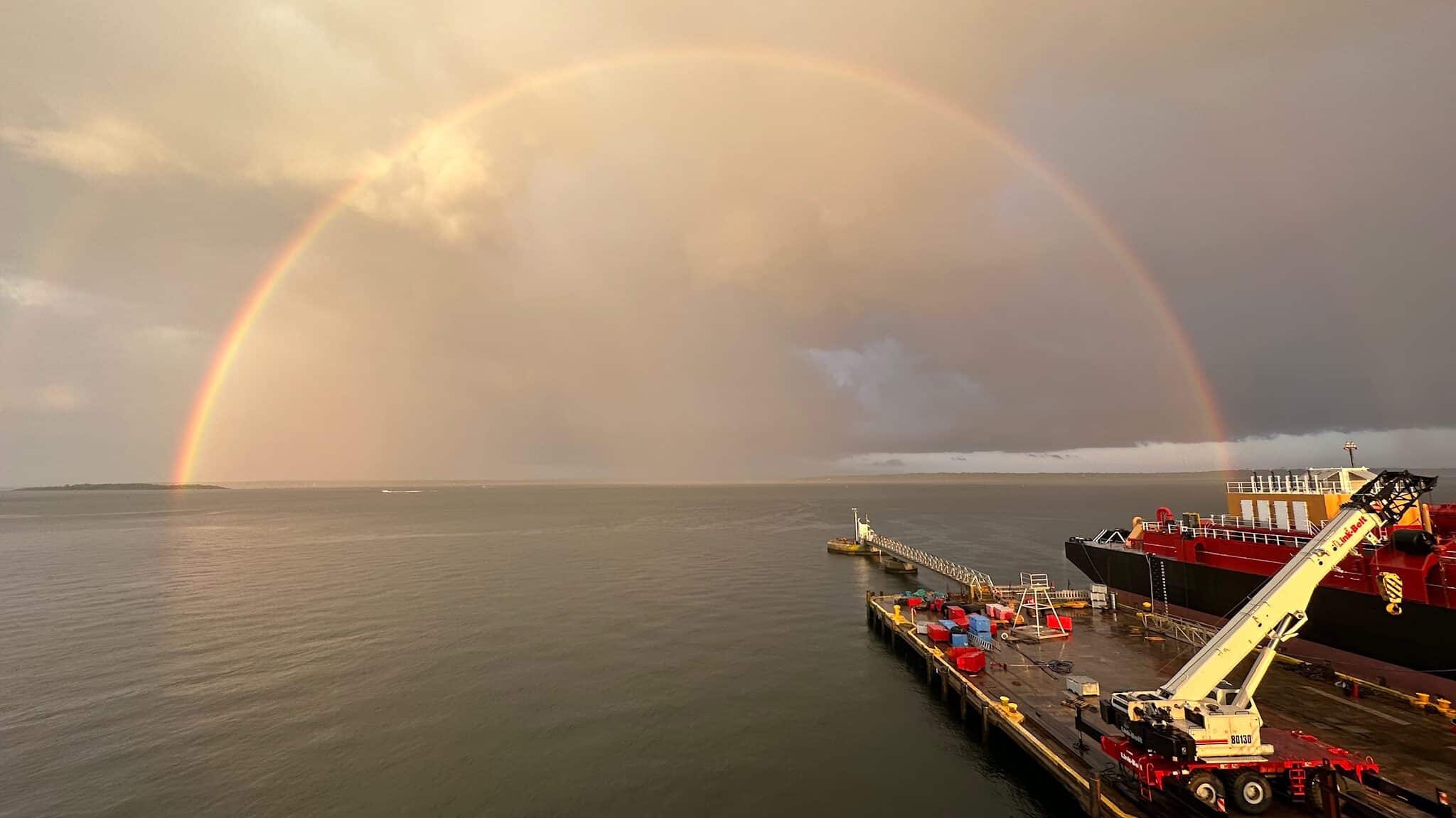 Compulsory Pilotage Rainbow over ocean and dock